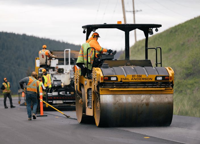 Paving equipment and a team of construction workers