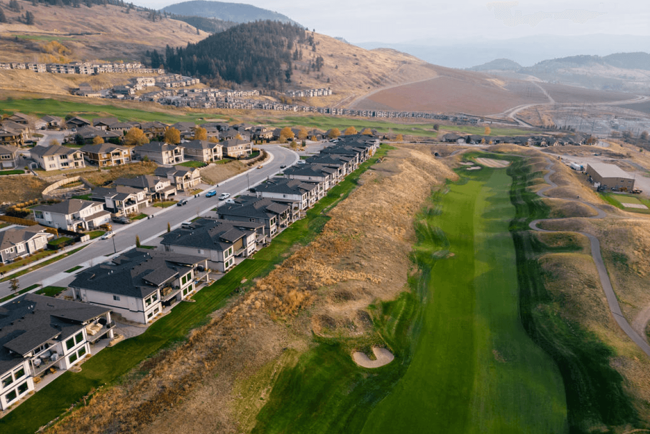 Golf fairway at Tower Ranch in Kelowna with adjacent suburban development